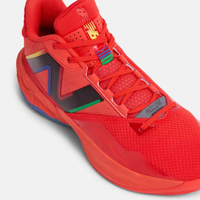 Side view of a red and black New Balance basketball shoe.